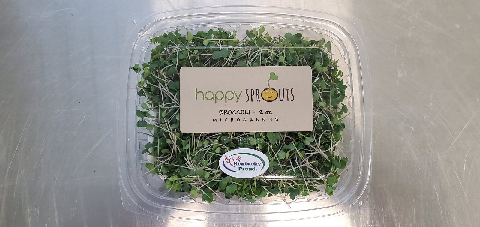 Happy Sprouts broccoli microgreens in a clamshell with a Kentucky Proud label